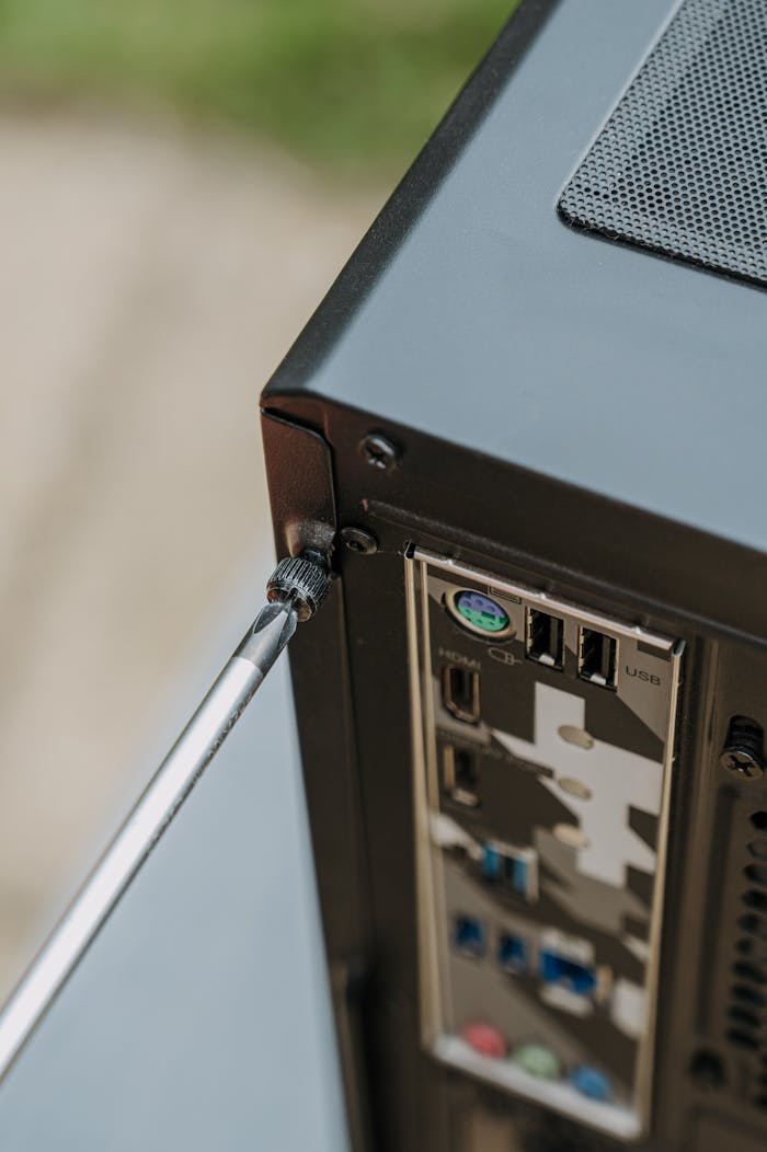 Close-up of unscrewing a PC